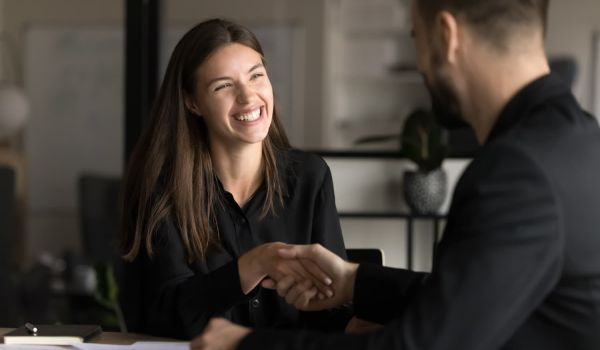 Happy business customer shaking hands